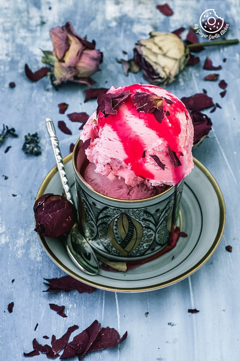 rooh-afza ice cream with some dried rose petals and rose syrup
