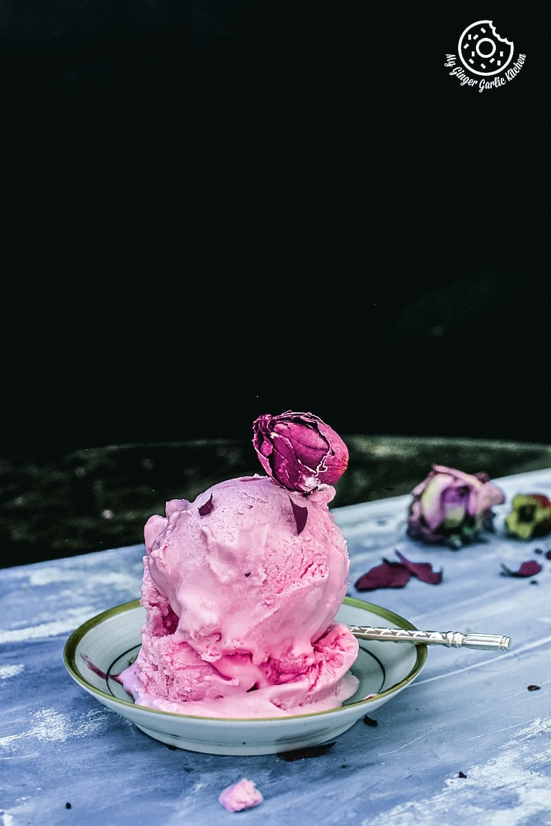 scoops of rose ice cream decorated with a rosebud