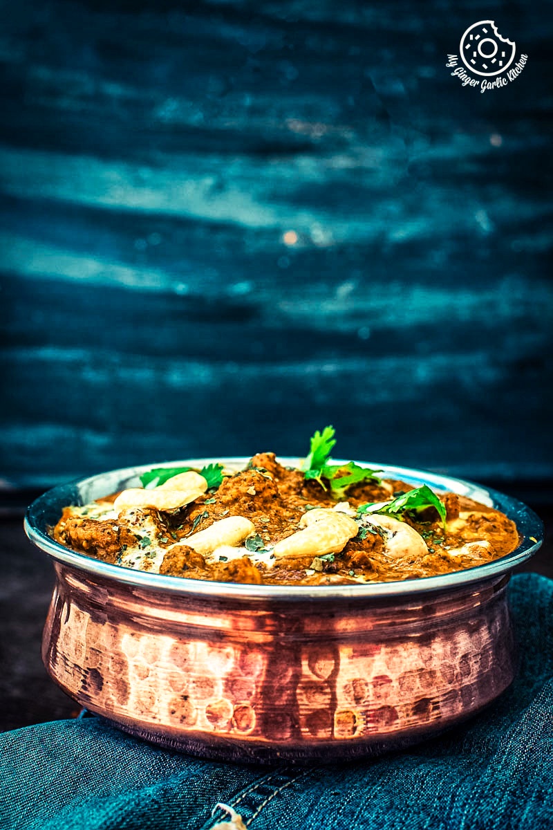 closeup shot of kaju curry served in a metal bowl