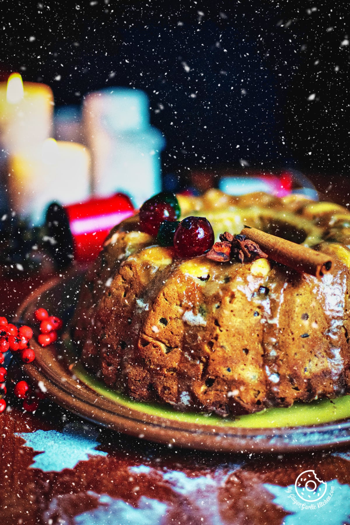 fruit cake topped with cherries and a cinnamon stick