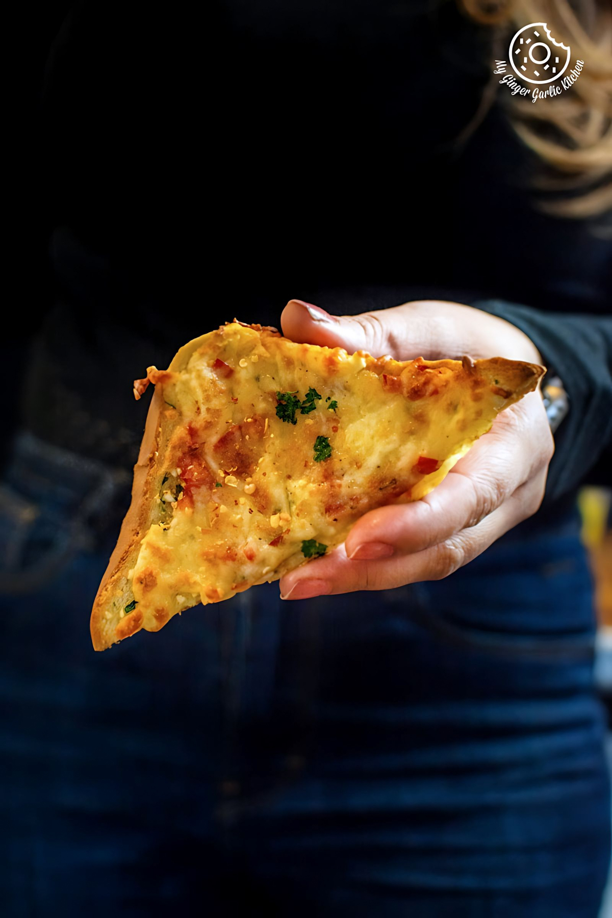 a hand holding chilli cheese toast