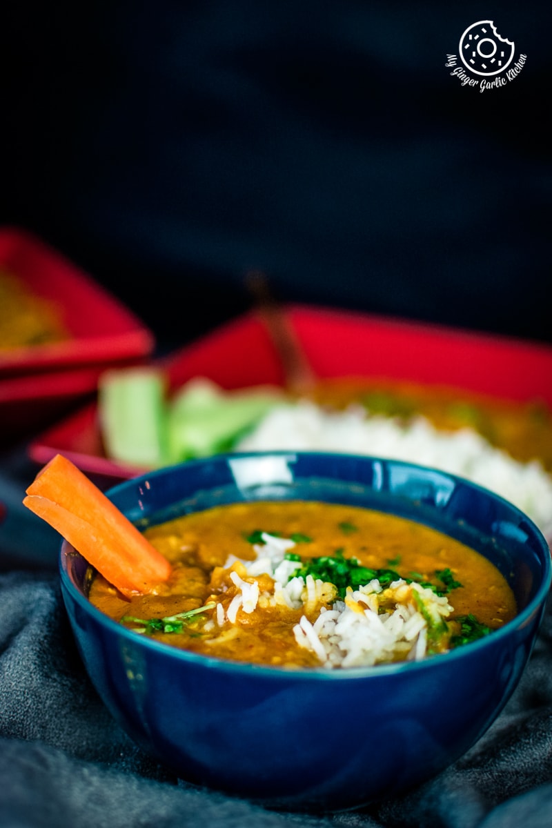instant pot masoor dal served in a dark blue bowl with some steamed rice