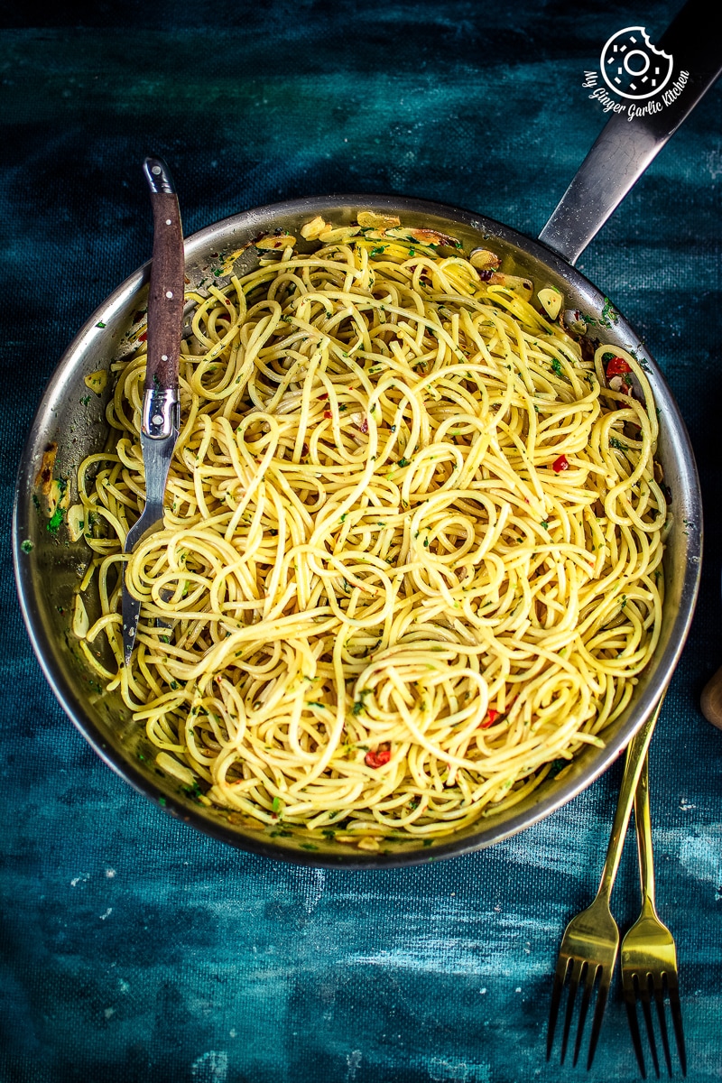 overhead shot of pasta aglio e olio in a steel pan