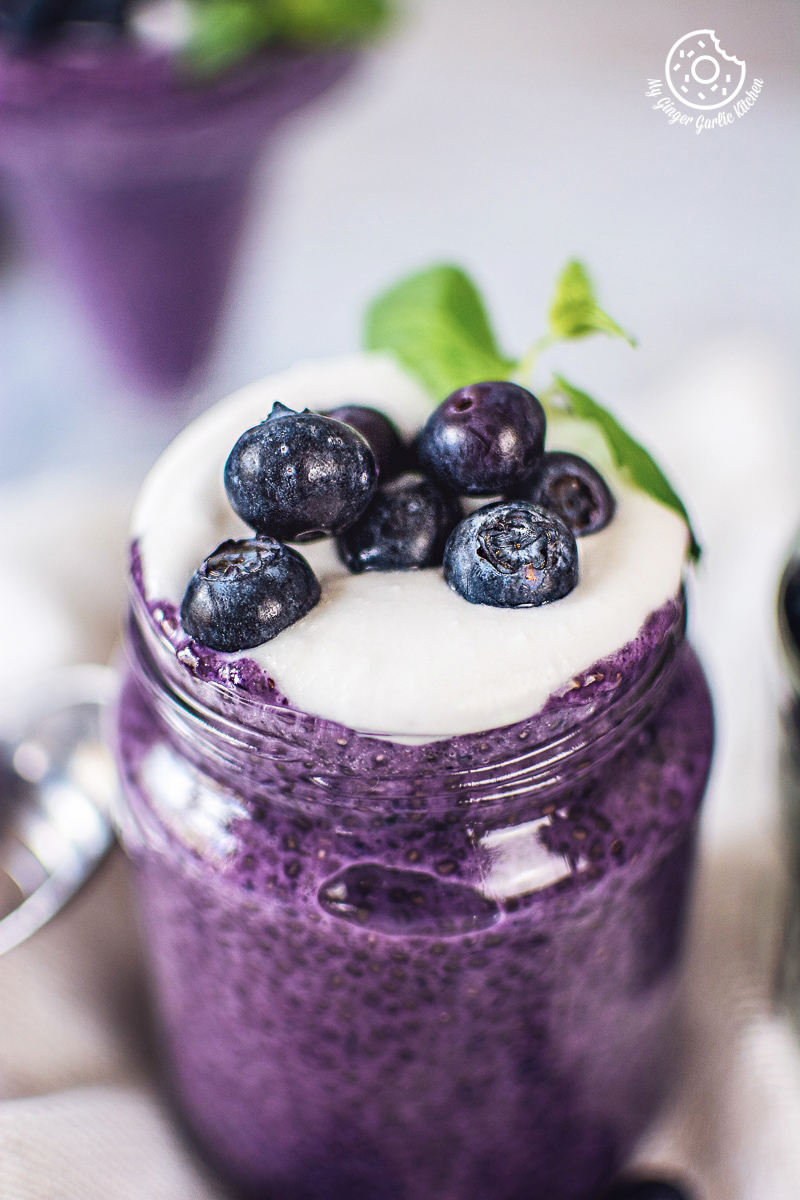 bluberry chia seed pudding topped with blueberries served in a jar