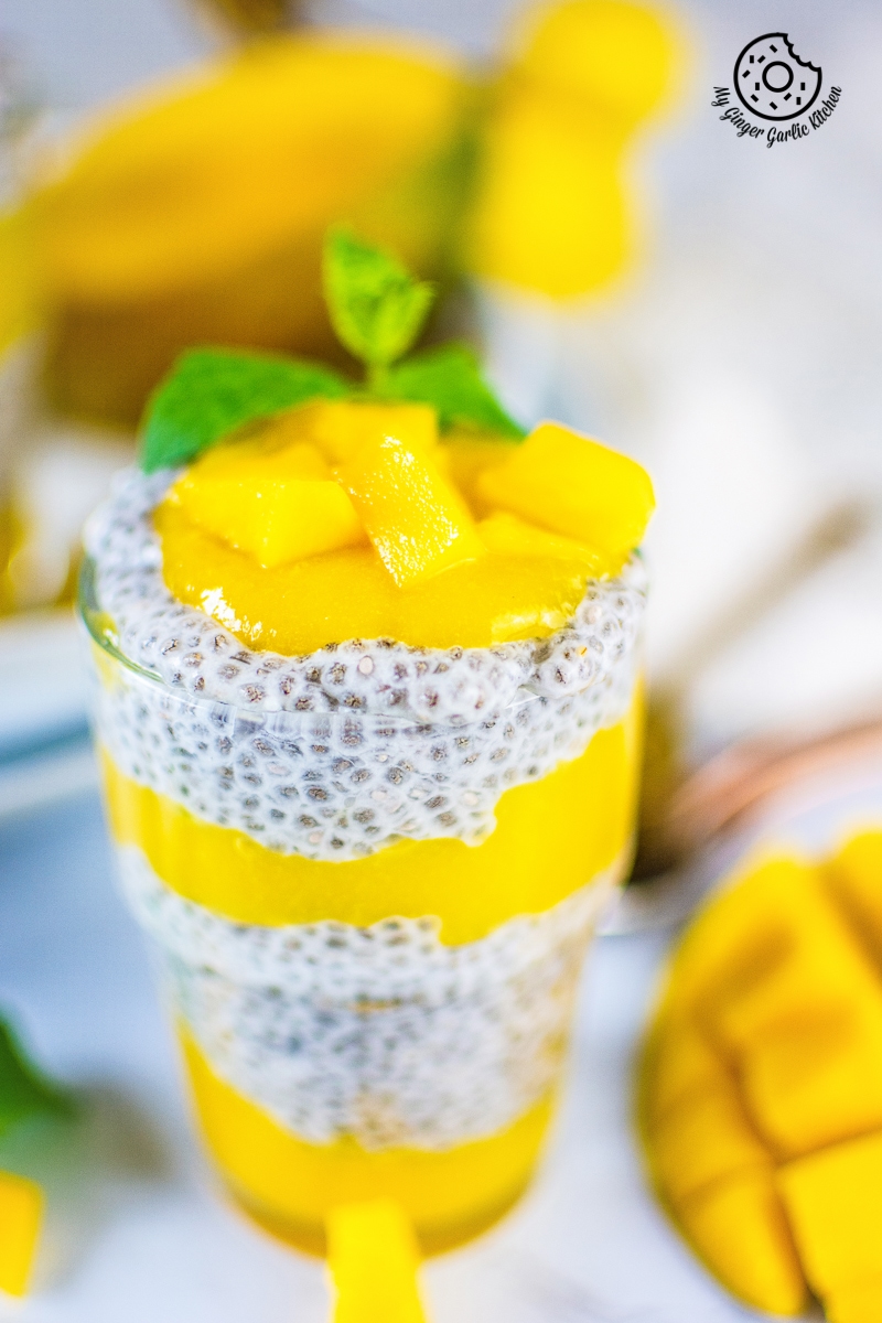 coconut mango chia pudding topped with mangoes