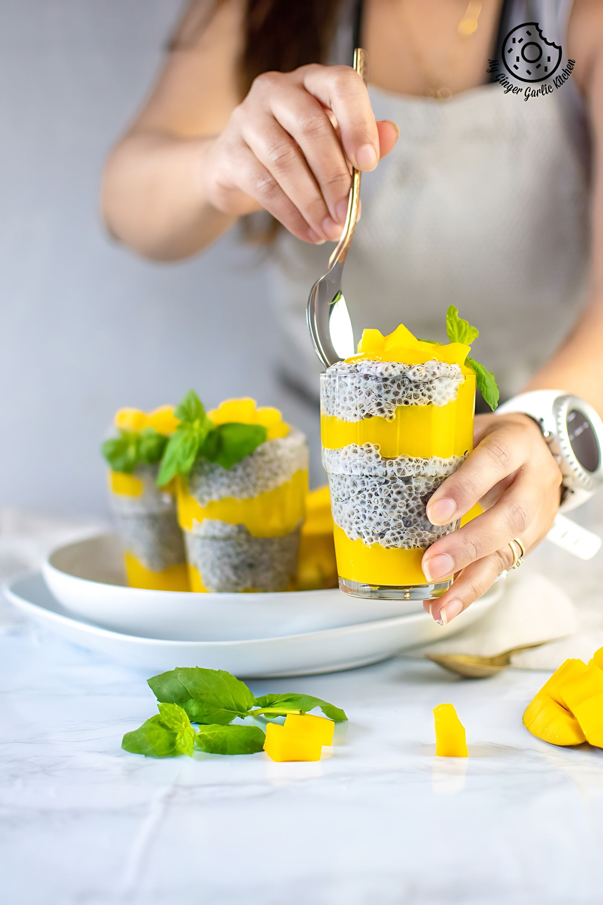 coconut mango chia pudding topped with mangoes