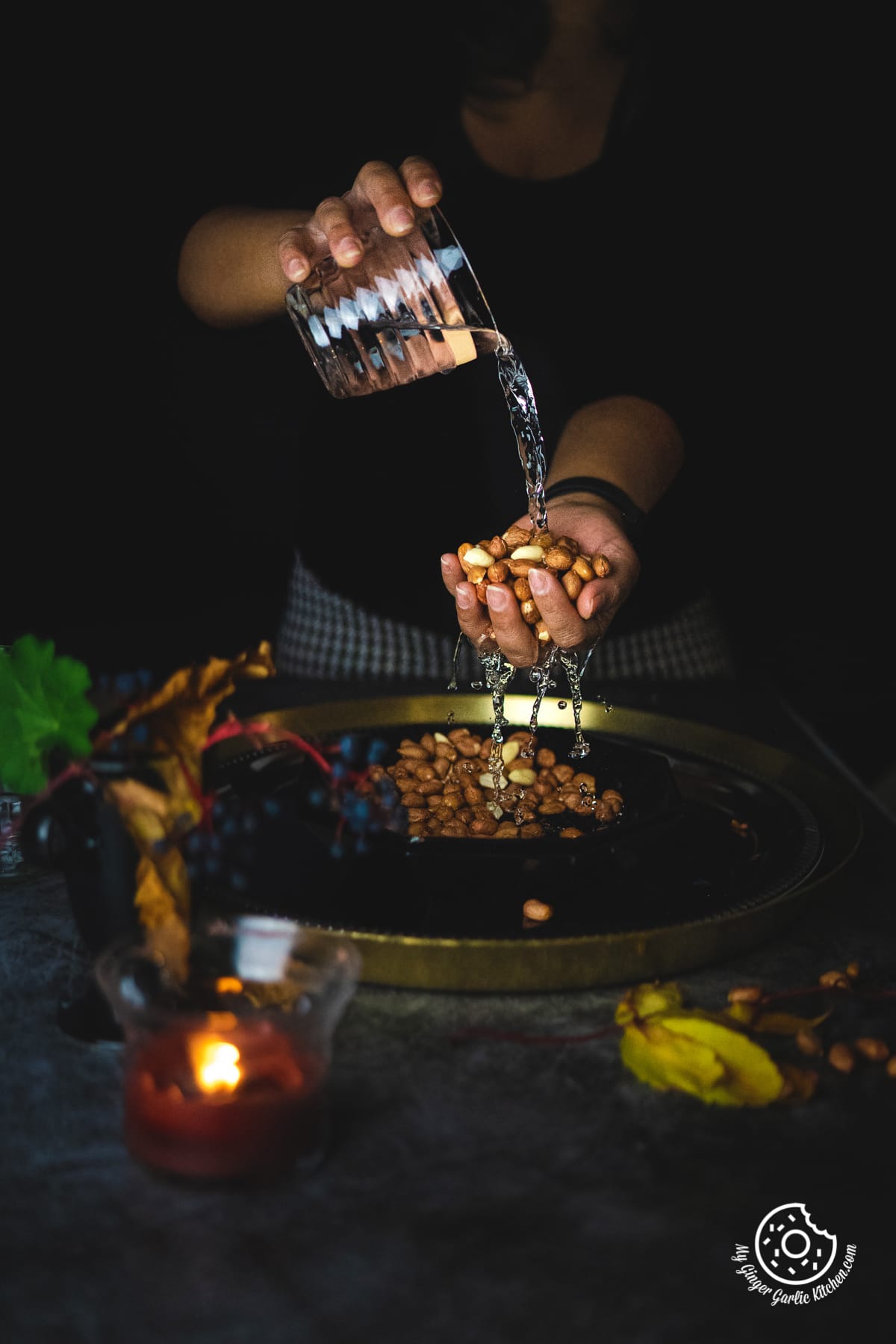a woman rinsing raw peanuts with water