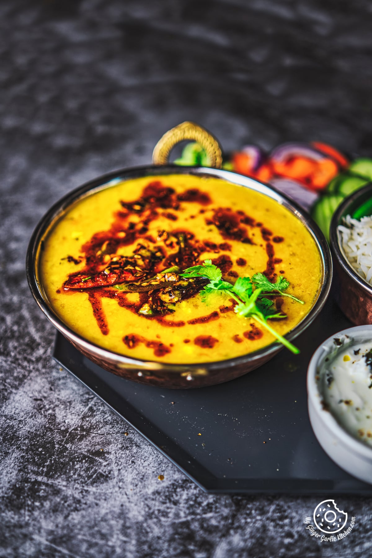 toor dal tadka served in a copper bowl