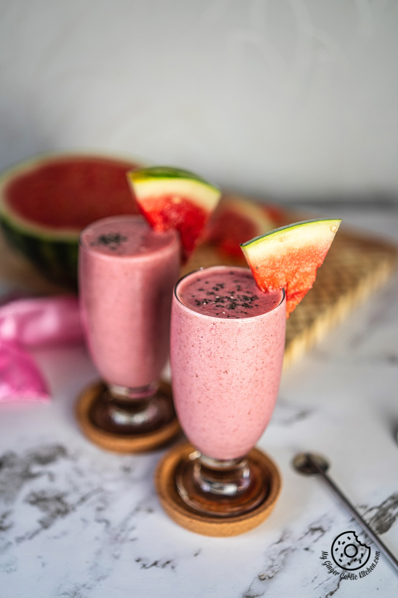 two watermelon smoothie glasses with chia and watermelon slices