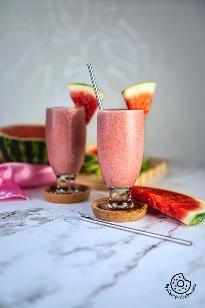 two watermelon smoothie glasses with chia and watermelon slices