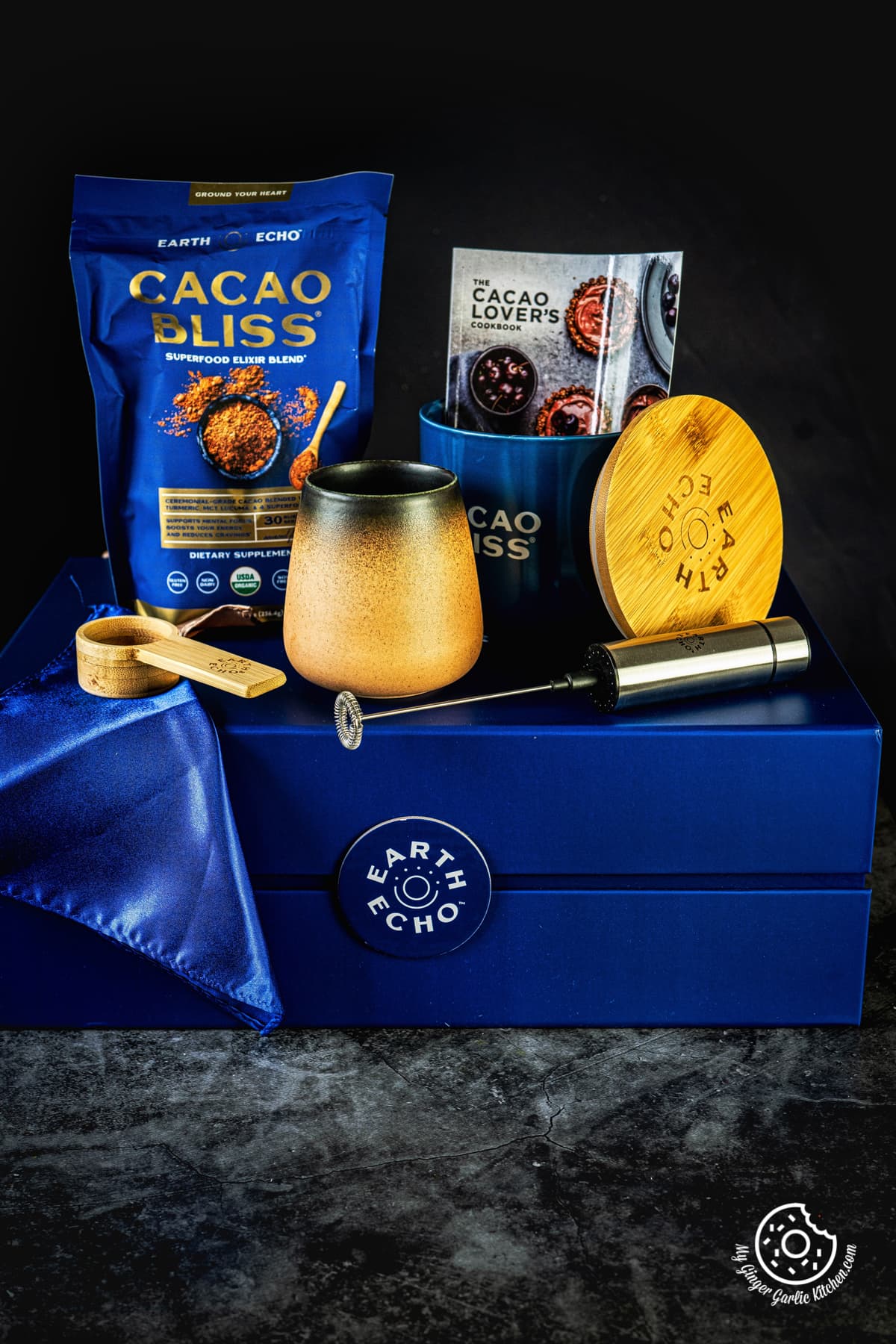 cacao bliss chocolate powder and mug kept on a blue box