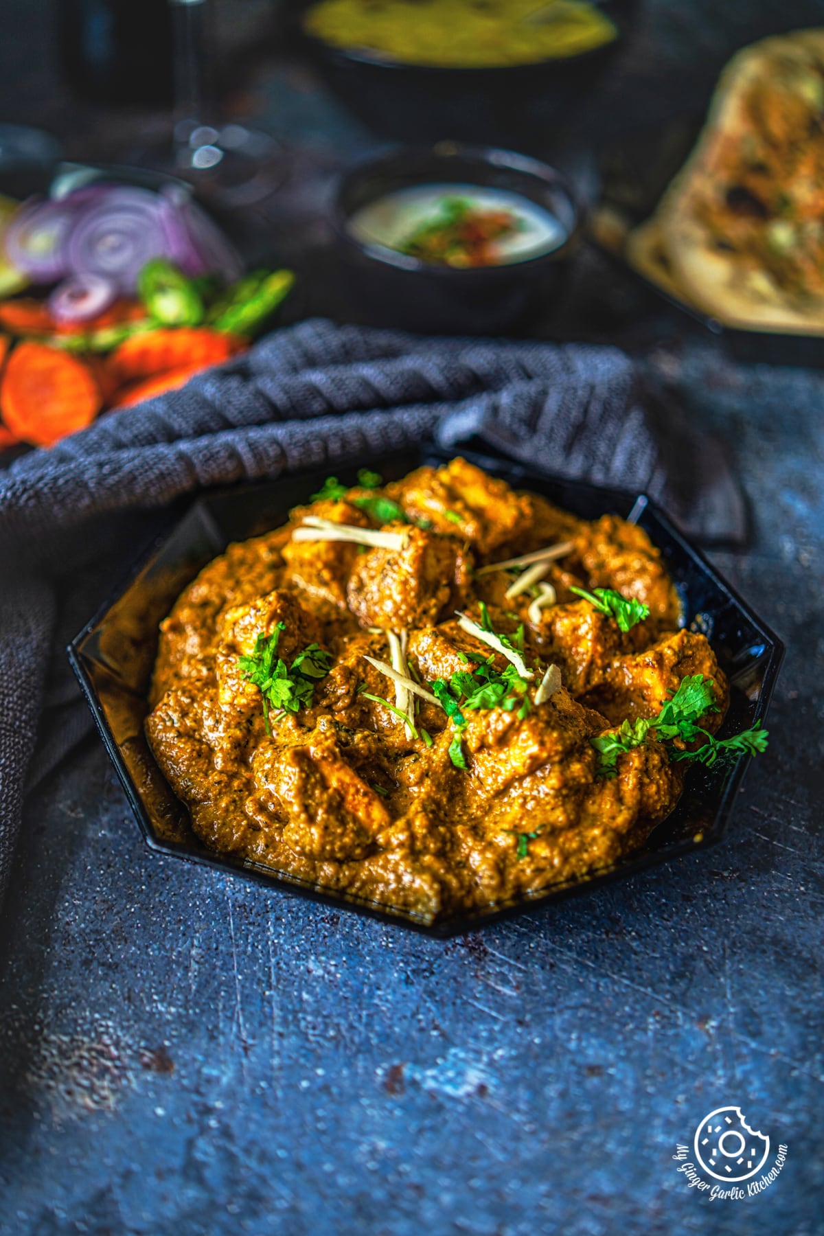 paneer korma curry served in a black plater