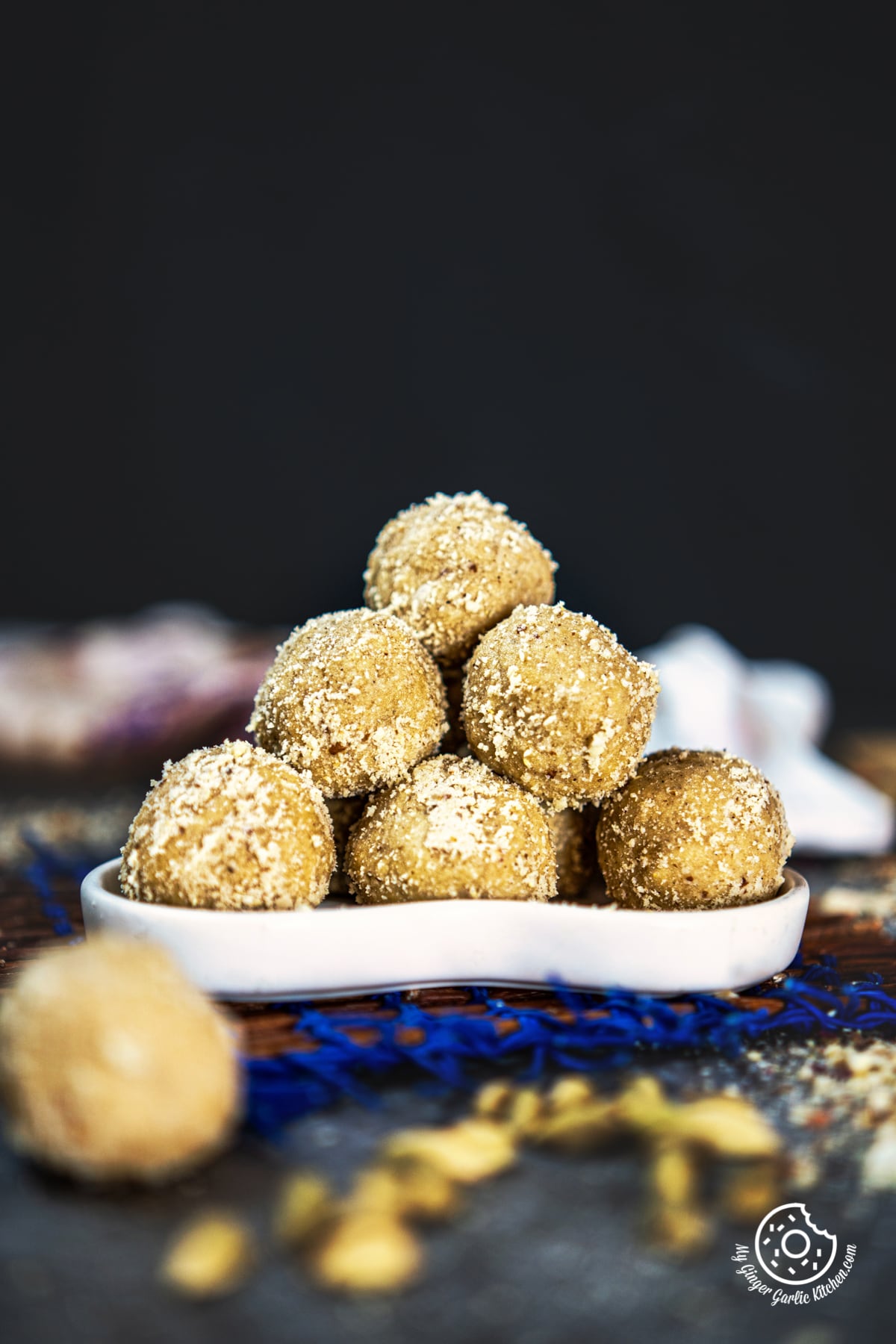 stack of peanut ladoos on a white plate