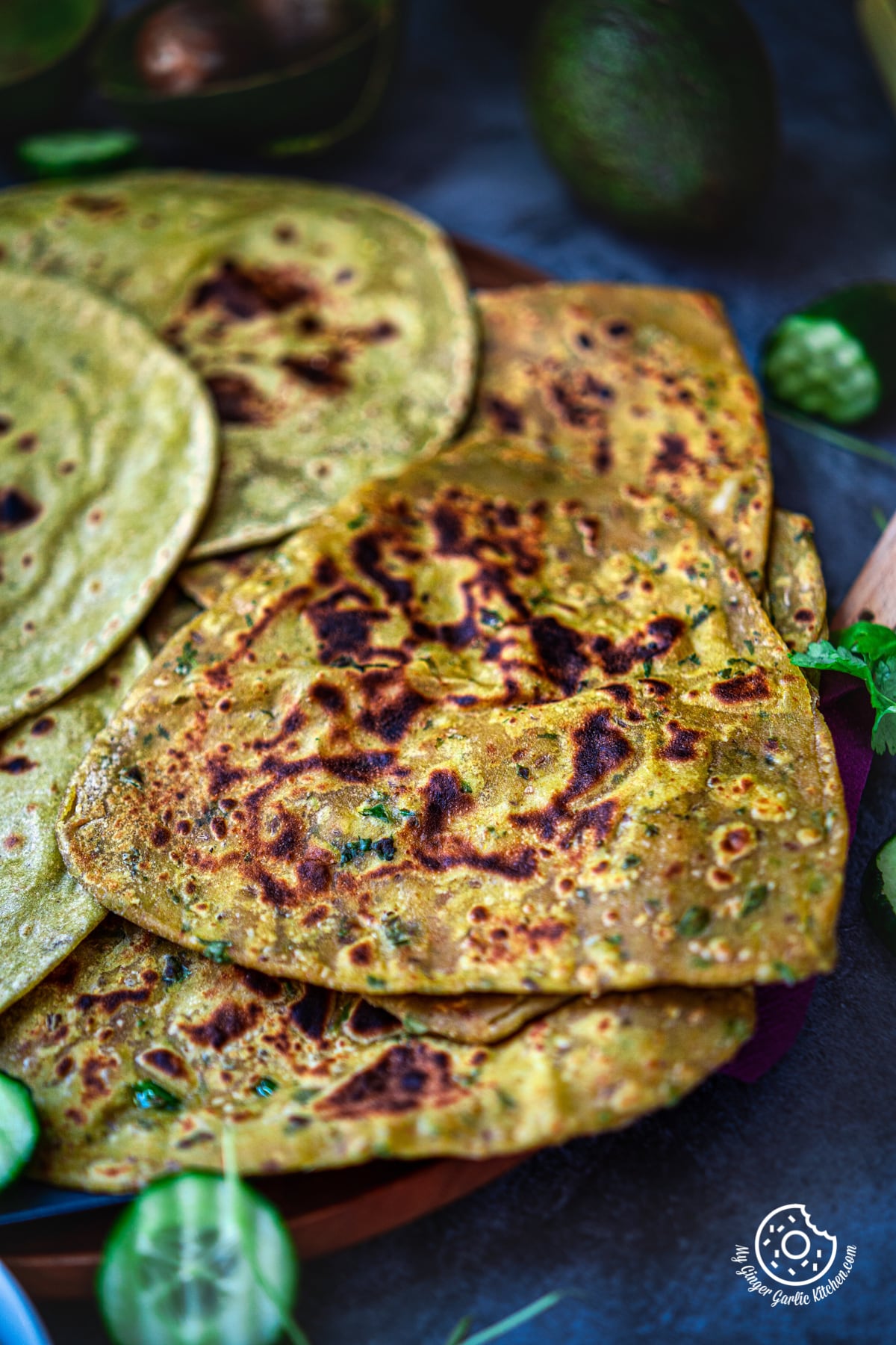 one rolled avocado roti kept on three rotis