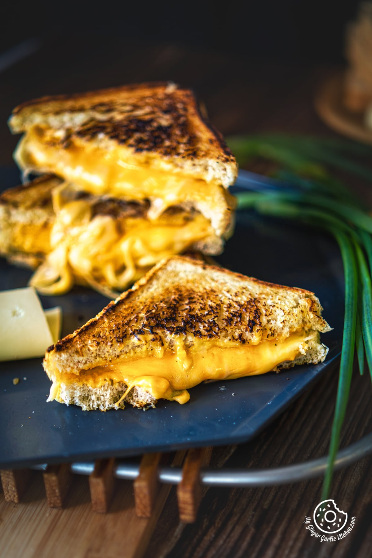 grilled cheese sandwich cut in half showing melting cheesy