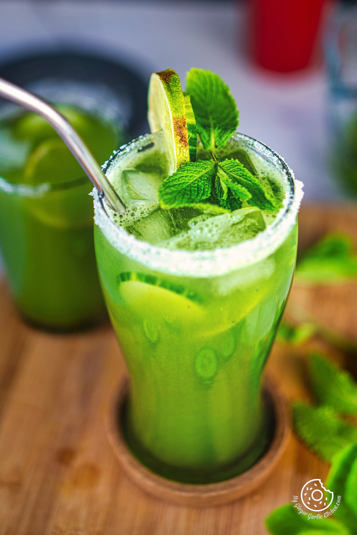 a closeup shot of cucumber cooler topped with mint fresh leaves