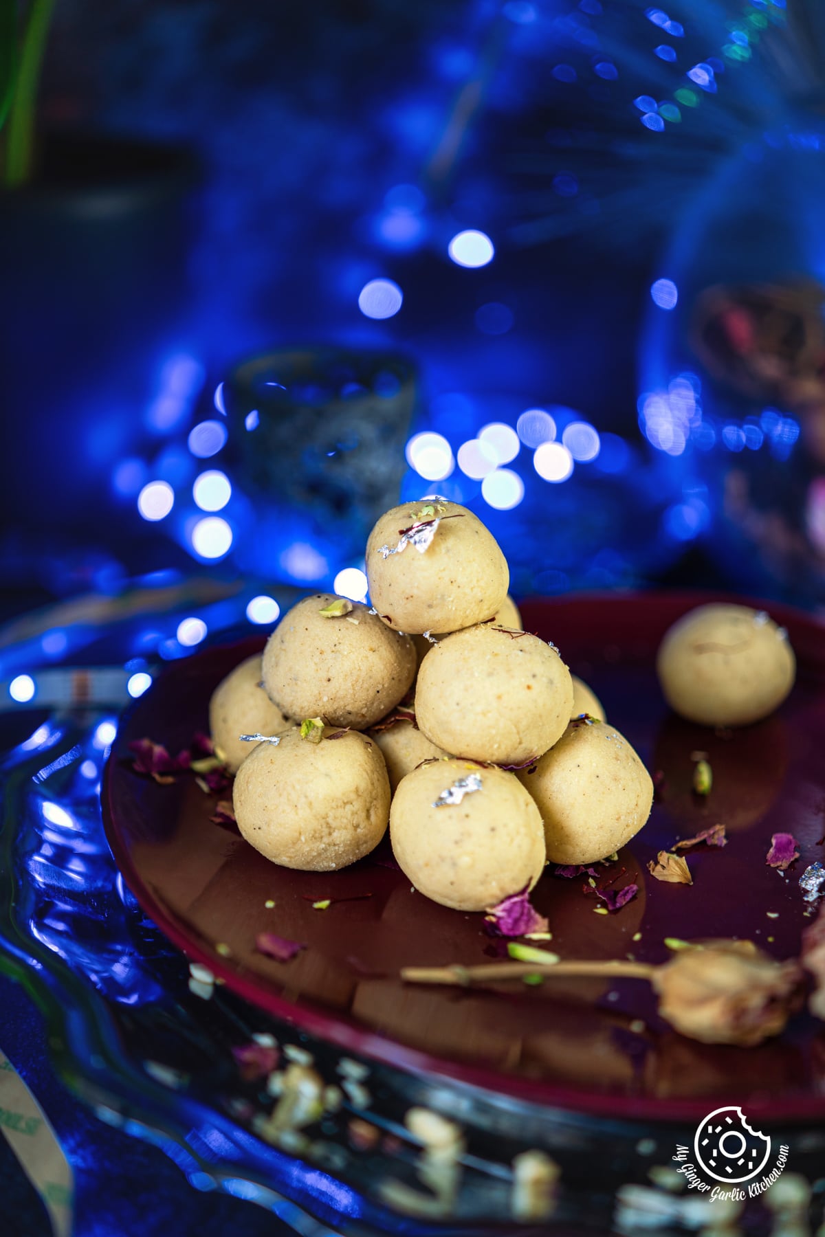 a stack of malai ladoo on a maroon plate
