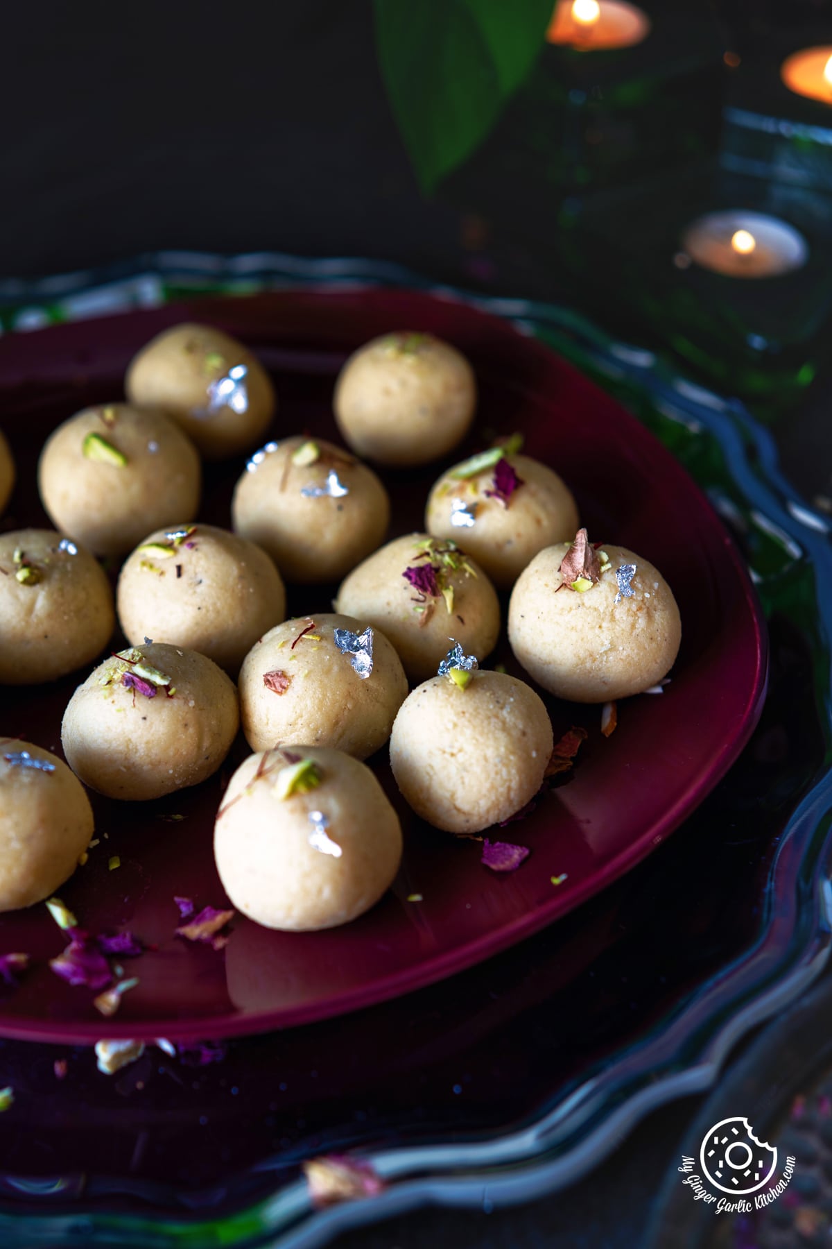 close up shot of malai ladoo in a maroon plate