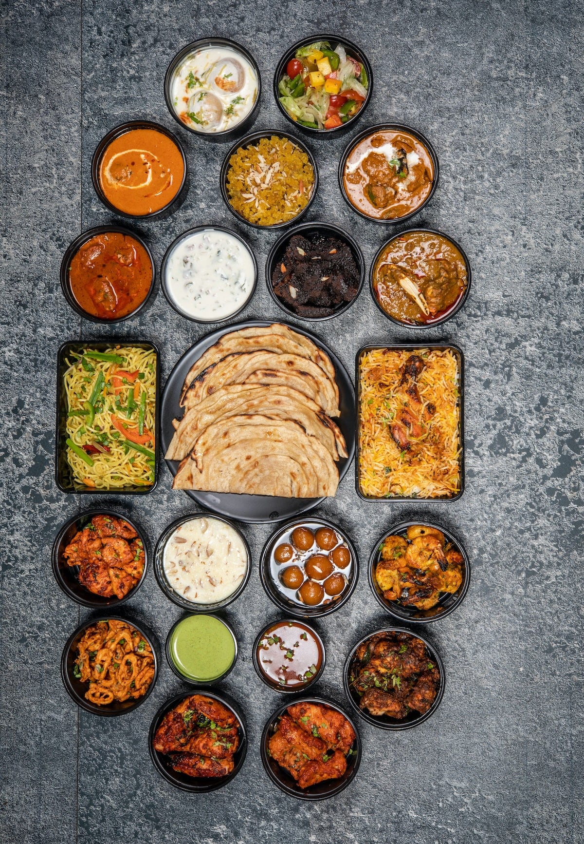 overhead shot of 22 indian dishes