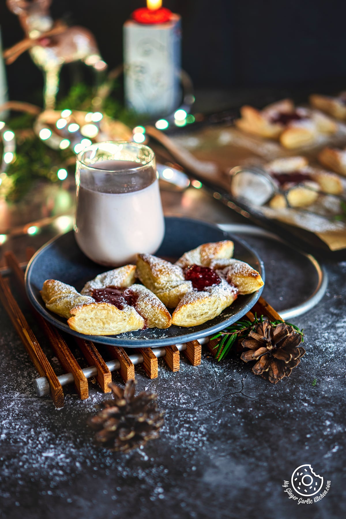 2 Joulutorttu - Finnish Christmas Tarts in a grey ceramic plate with a glass of milkshake