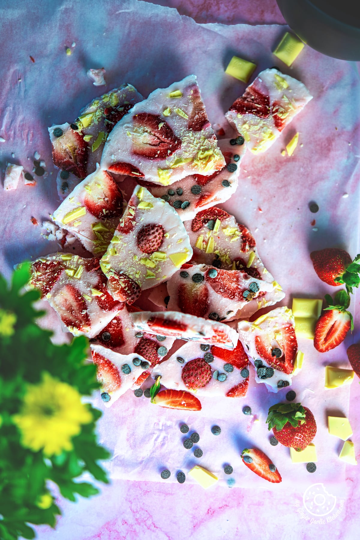 overhead shot of strawberry yogurt bark with chocolate chip and strawberries on the sliced
