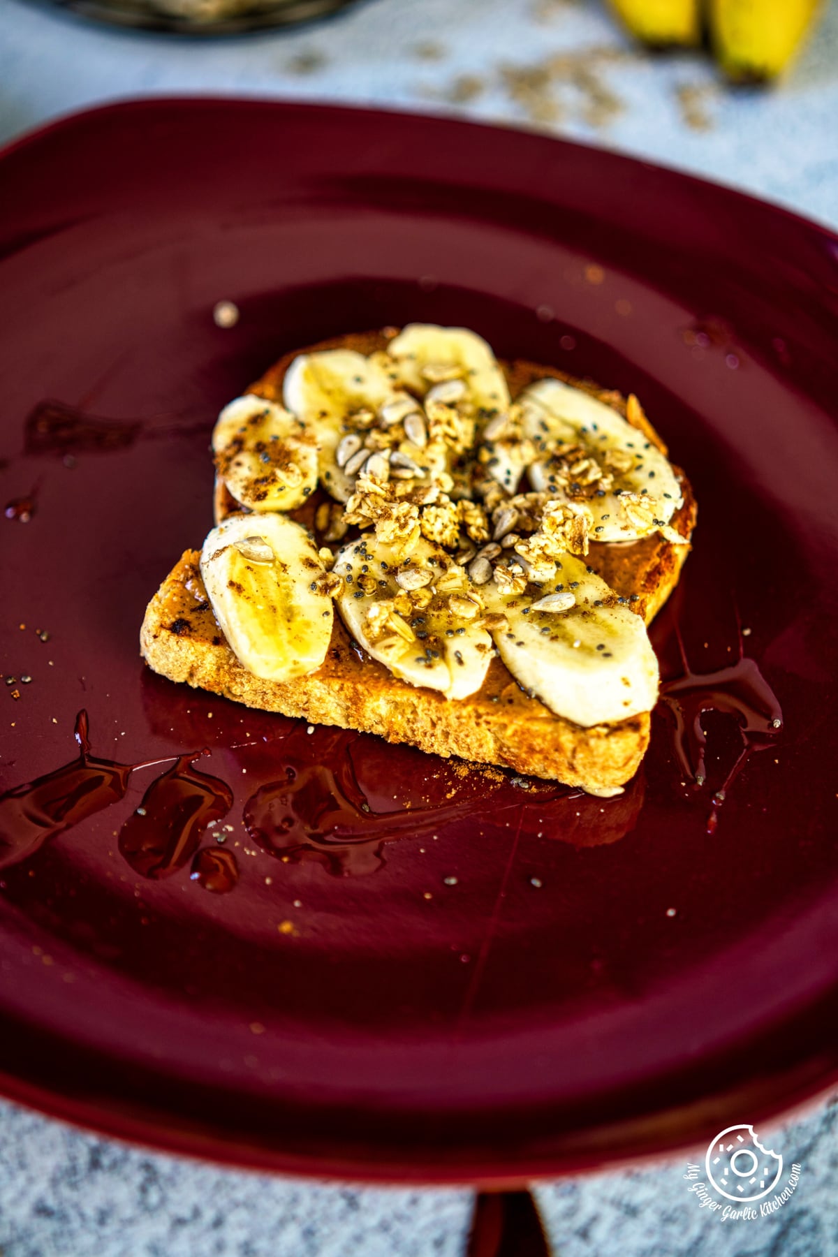 photo of a plate with a piece of peanut butter banana toast